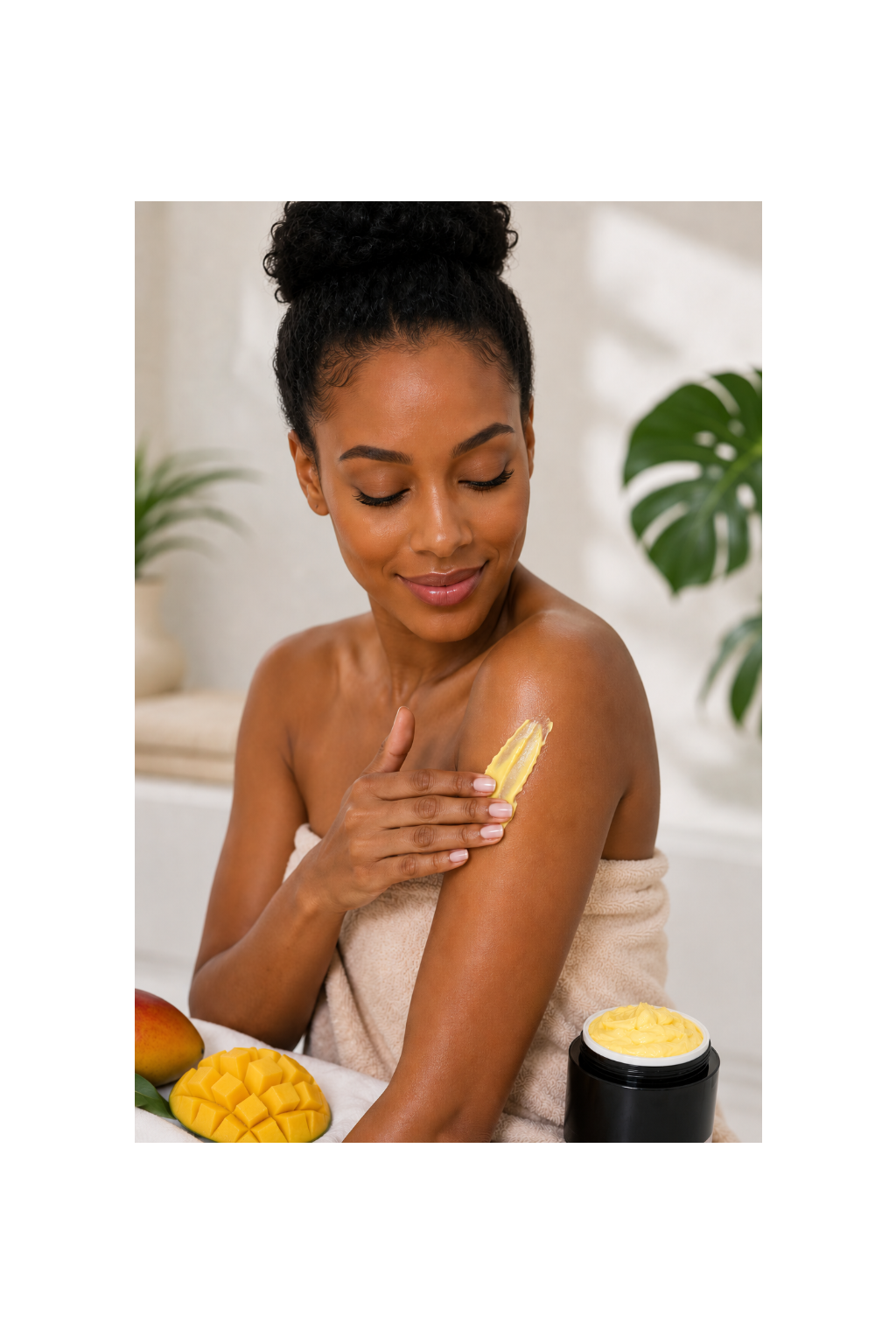 Woman applying the mango body butter to her arm with mangos and a plant in the background